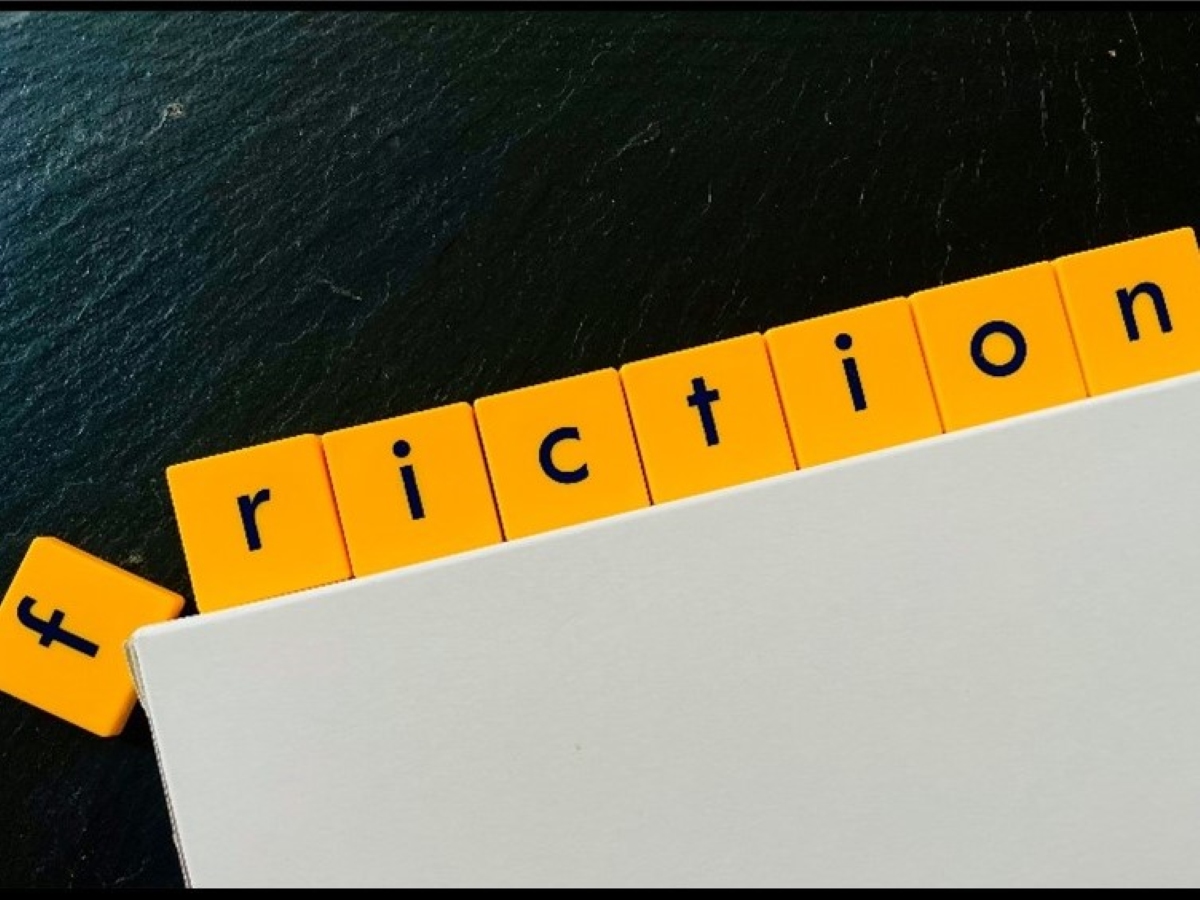 Representation of friction using scrabble tiles that spell the word friction on a slope