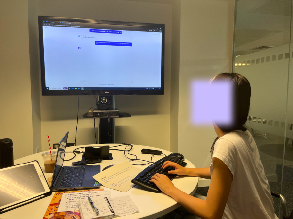 A participant interacting with a chatbot during testing session.