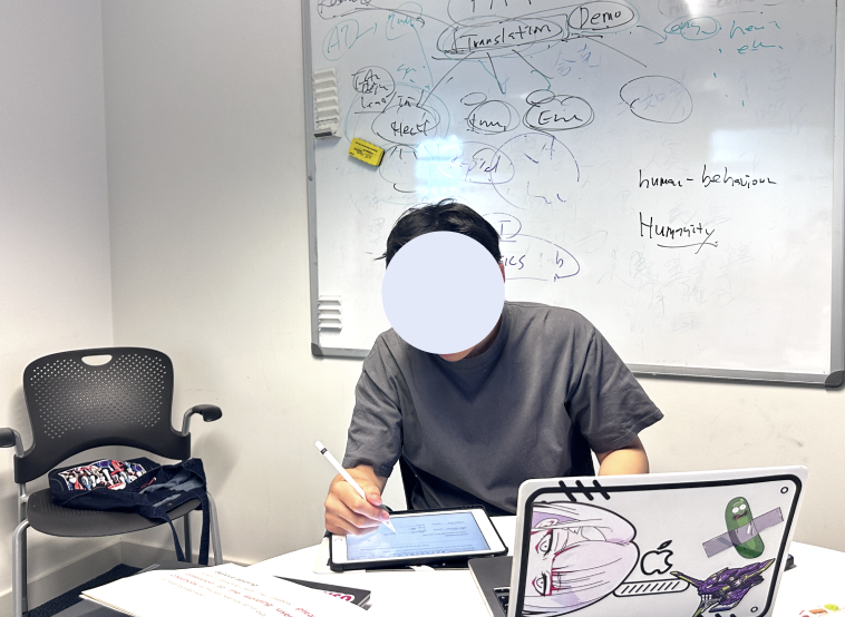 A participant engaged in a usability testing session, using a tablet for interaction. In the background, a whiteboard with handwritten notes and diagrams is visible, indicating a brainstorming or analysis process.